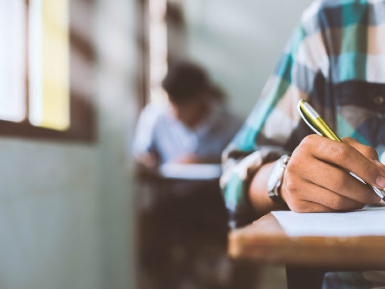 close-up-students-writing-reading-exam-answer-sheets-exercises-classroom-school-with-stress