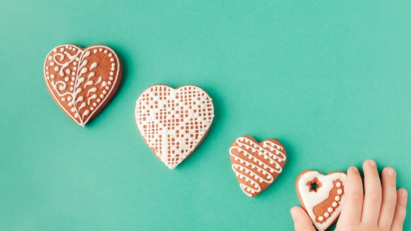 mengembangkandiri.com_four-gingerbread-cookies-on-green-childrens-hand-2022-02-24-06-34-41-utc