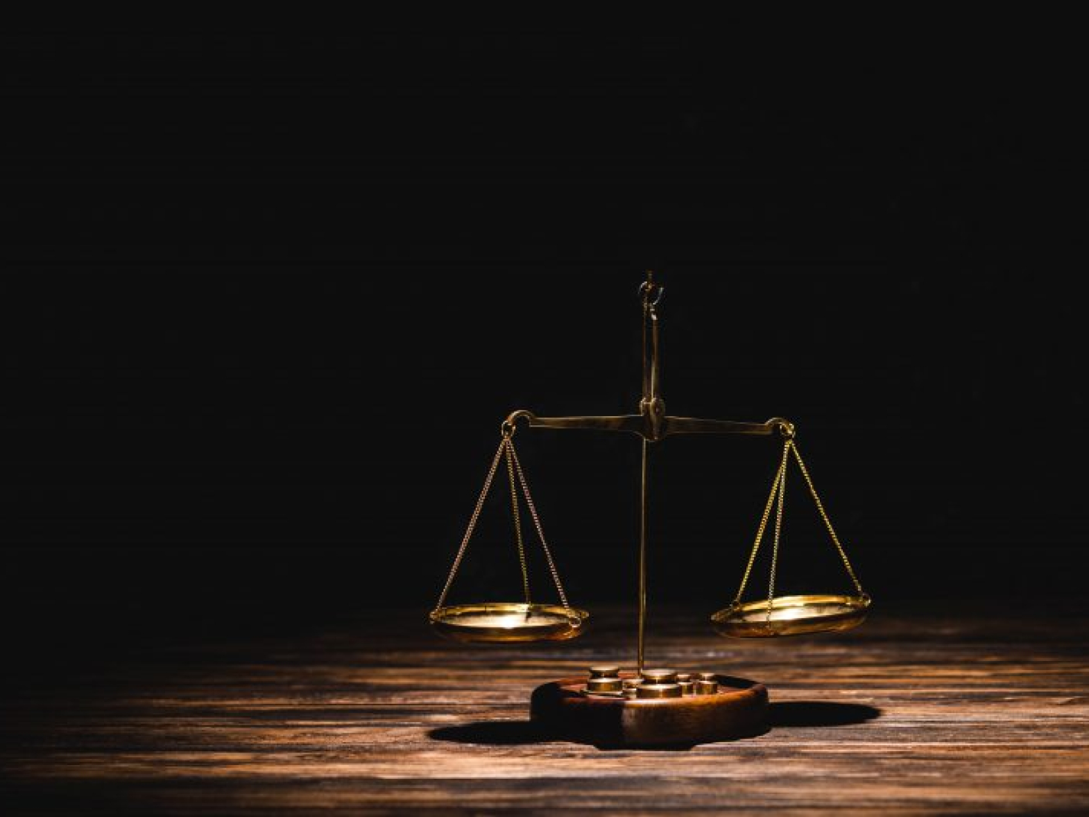 mengembangkandiri.com golden-scales-of-justice-on-wooden-table-on-black-2021-09-01-13-07-28-utc